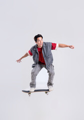 Portrait of asian man playing skateboard on white background