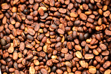 Fototapeta premium In the honey process, coffee beans are dried under the sun. As the pulp and mucilage ferment, they give the beans a yellowish-brown color.