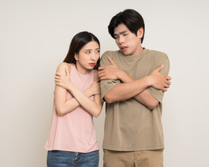 Young asian man and woman feel cold. Frozen Winter season. Hugging them self warming up...