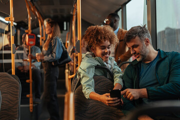 Teenage girl showing her dad something on the phone