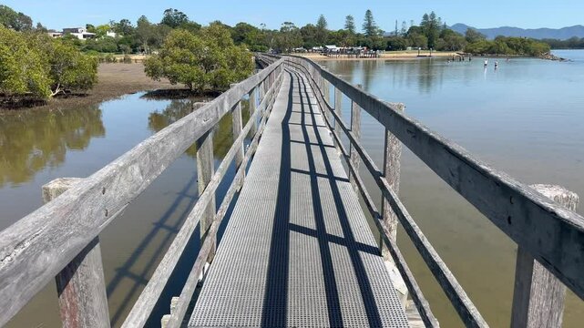 Aerial drone landscape view of Urunga Wetlands wooden boardwalk in New South Wales Australia.