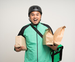 Young asian rider wearing green jacket uniform and helmet various action holding a lot of paper...