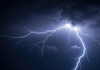 A dramatic display of lightning illuminates the night sky during a thunderstorm.