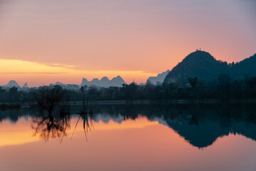 Golden Dawn on Li River: Misty Karst Peaks Reflecting in Mirror-Still Waters – Guilin's Ethereal Morning Symphony