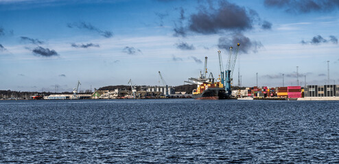 Seaport With Cargo Containers and Cranes Under a Clear Sky