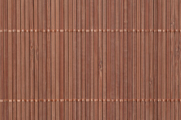close up of mat made of brown bamboo planks