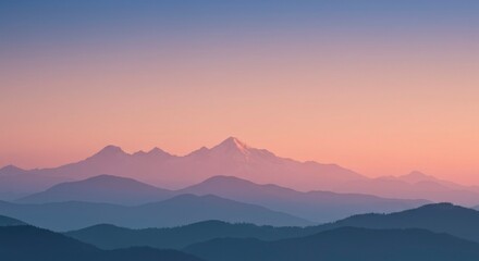 Fototapeta premium Mountain range at sunrise. Soft, hazy colors paint the peaks