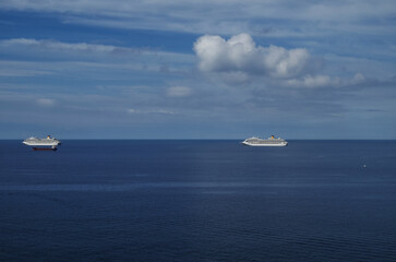 Mega family cruiseship cruise ship liners Favolosa and Fortuna anchored offshore of Civitavecchia Rome, Italy before reactived after Covid pandemic with other vessels in port and coastline