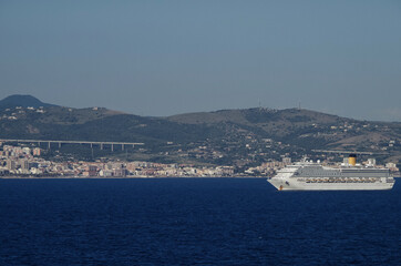 Mega family cruiseship cruise ship liners Favolosa and Fortuna anchored offshore of Civitavecchia Rome, Italy before reactived after Covid pandemic with other vessels in port and coastline