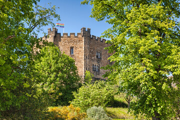 Fototapeta premium The old keep of Durham Castle, now part of Durham University, surrounded by trees in full leaf.