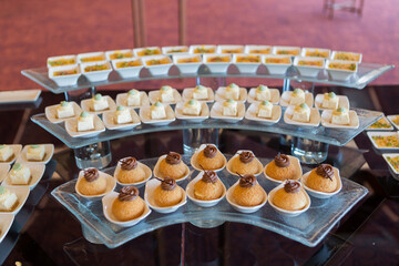 An elegant table filled with assorted desserts and pastries, beautifully arranged for a special event, offering a tempting selection of sweet treats.