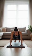 Fit woman balances doing plank exercise at home on mat indoors for wellness workout routine