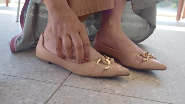 low angle view of women suffering itching skin on her feet 