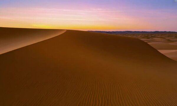Beautiful sand dunes in the Sahara desert at sunset