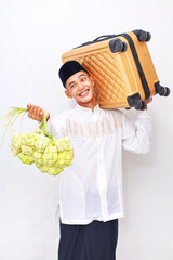 Cheerful Asian Muslim Man Traveling for Eid with Suitcase and Ketupat