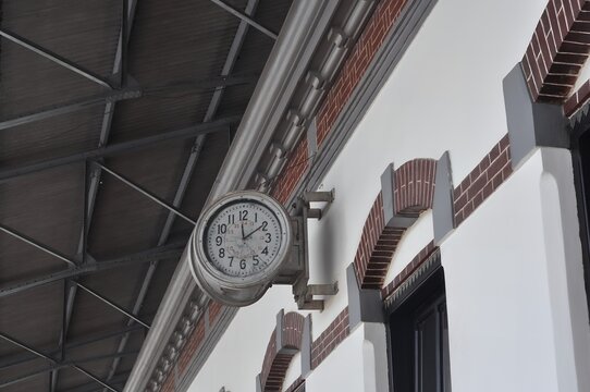 The building has a unique architectural style. The image has a vintage aesthetic with a focus on time and history.
