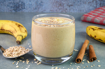 Serving banana oat smoothie in a glass cup.