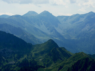 mountain landscape with dark green peaks and cloudy sky