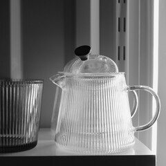 Traditional glass teacup and teapots with chrome handles in the night kitchen. Clean glass...