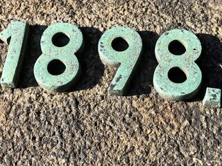 The year 1898 in raised green numbers