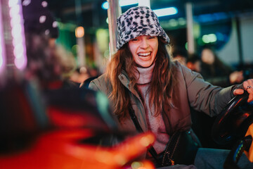 Young woman smiling and embracing joy while engaging in a recreational activity at night. The vivid...