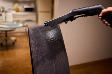 Using a Vacuum Cleaner for Upholstery Cleaning in a Modern Interior Design Setting