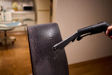 Using a Vacuum Cleaner for Upholstery Cleaning in a Modern Interior Design Setting