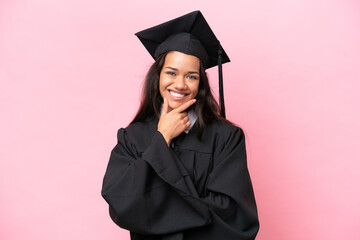 Young university Colombian woman graduate isolated on pink background smiling