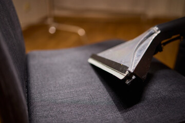 Using a Vacuum Cleaner for Upholstery Cleaning in a Modern Interior Design Setting