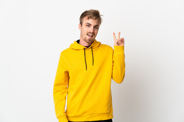 Young handsome man isolated on white background smiling and showing victory sign