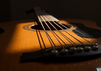 Fototapeta premium Acoustic Guitar Close Up with Sunlight Casting Shadows on the Instrument