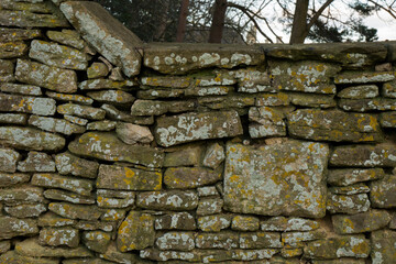 Aged dry stone wall, constructed from irregularly shaped stones 1