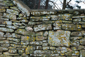 Aged dry stone wall, constructed from irregularly shaped stones 4