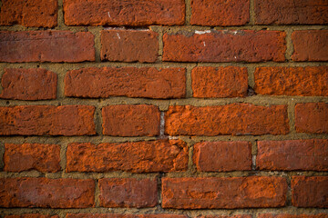 Obraz premium Traditional red brick wall, displaying a weathered and textured surface 1