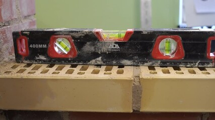 A special tool is a device for measuring the angle and flatness of the brickwork surface
