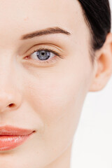 Fototapeta premium Mesmerizing woman with blue eyes looking straight into the camera. This shot perfectly conveys the essence of makeup, creating a connection between cosmetology and ophthalmology.