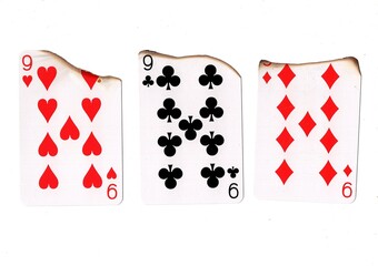 A hand of three burnt playing cards of the same value.