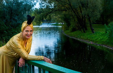 Beautiful girl wearing a turban and a stylized ethnic costume in the summer park. High quality photo