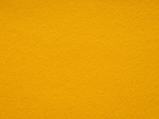 Naklejka premium Mustard yellow felt texture emanates warmth and rustic charm, ideal for cozy and inviting design themes