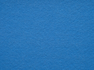 Vibrant sapphire felt surface, echoing with the depth of the ocean and the stillness of the sky
