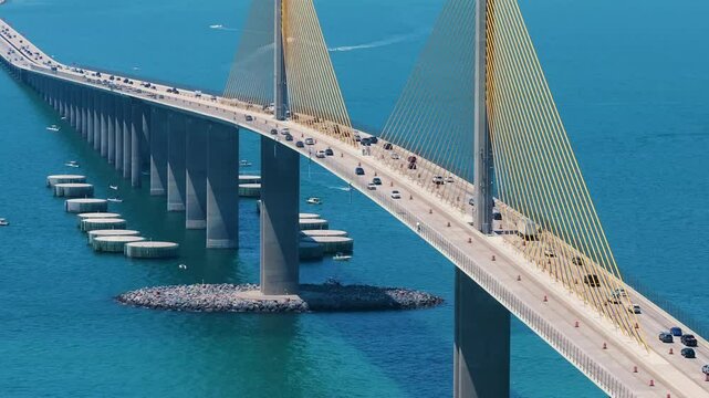 Highway road with driving traffic cars on Sunshine Skyway Bridge over Tampa Bay in Florida. Transportation infrastructure in USA