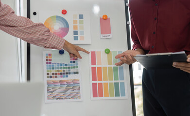 Color Selection and Collaboration. A creative team discussing color palettes for a design project.