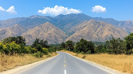 Fototapeta premium A scenic road leads towards towering mountains in the distance