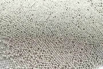 Texture of small metallic silver balls top view.