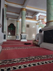 man praying in a mosque