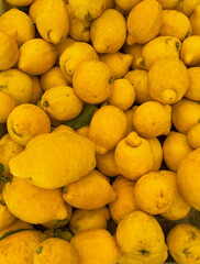 Pile of fresh Mediterranean lemons on a market stall in Menton, France.