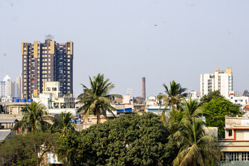 Urban Skyline View with Residential Buildings and Trees During Daytime