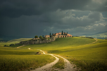 Fototapeta premium Landscape image of old village and dirt road on idyllic rolling hills