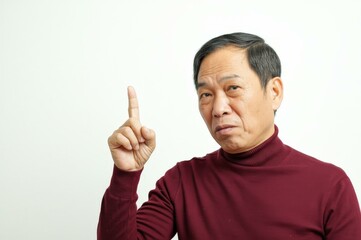 Fototapeta premium Serious Older Asian Man Maroon Turtleneck Gesturing White Background - Authority Effective Communication Concept Business Leadership Educational Presentations
