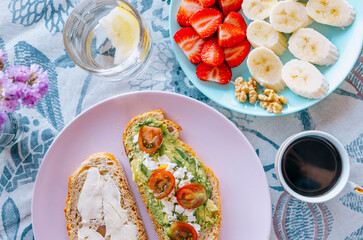 A vibrant breakfast spread with avocado toast, fresh fruit, and coffee